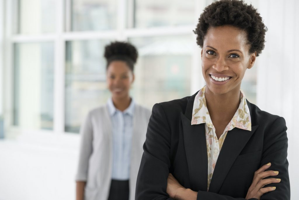 A business environment, a light airy city office. Business people. Two women.